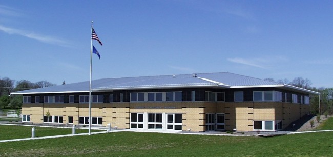 Extension office - brick office building with United States flag outside.