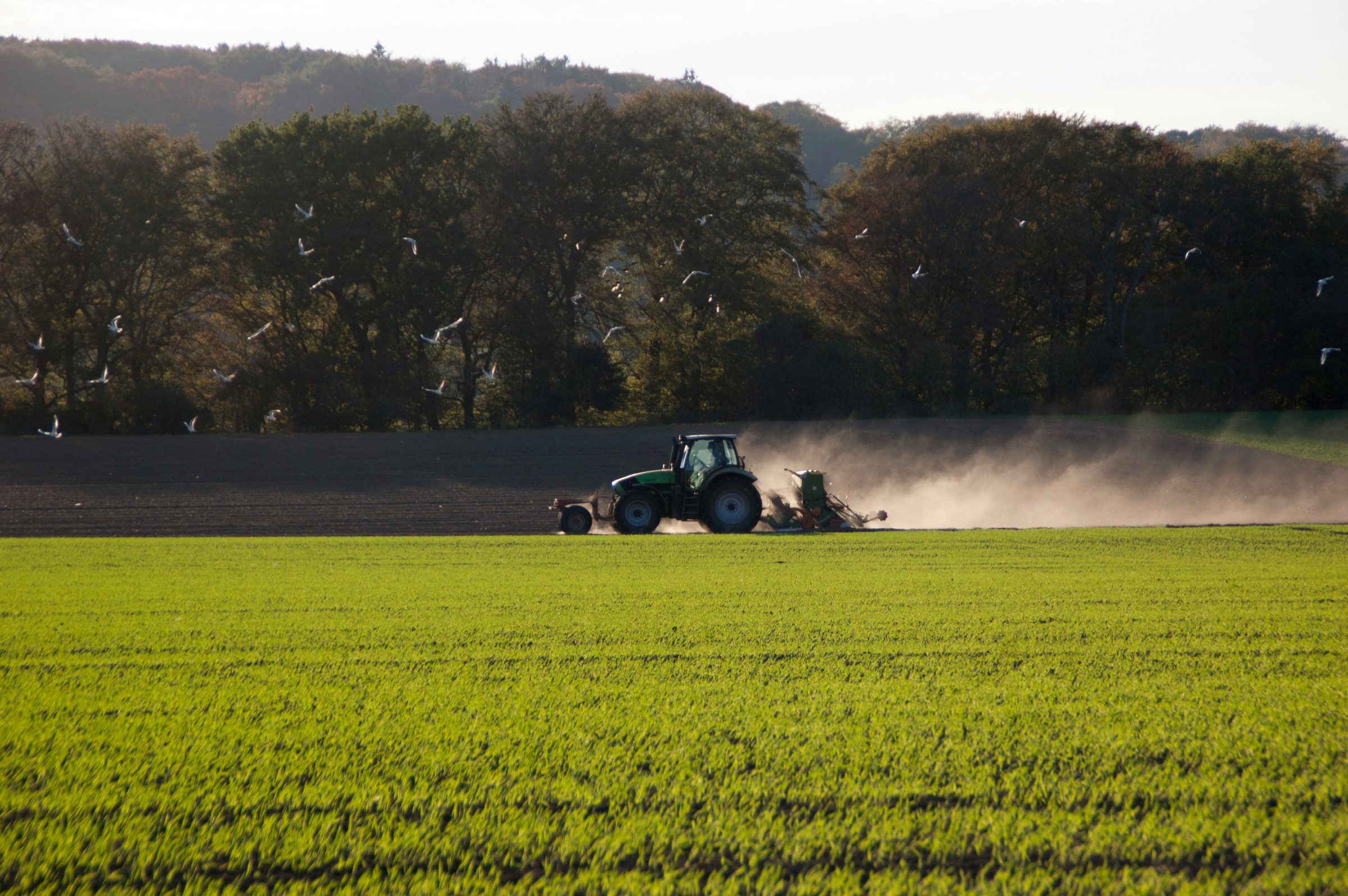 Tractor applying pesticide on a field