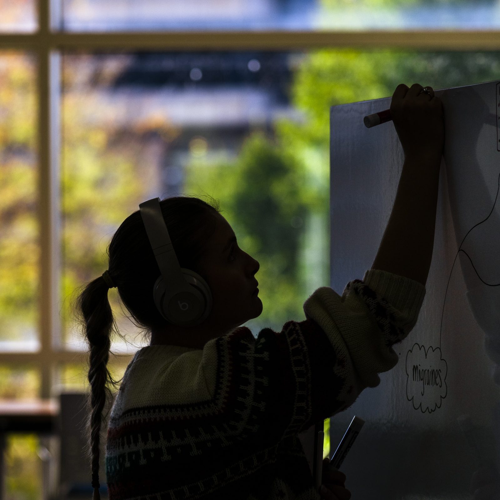 University student writing on a whiteboard