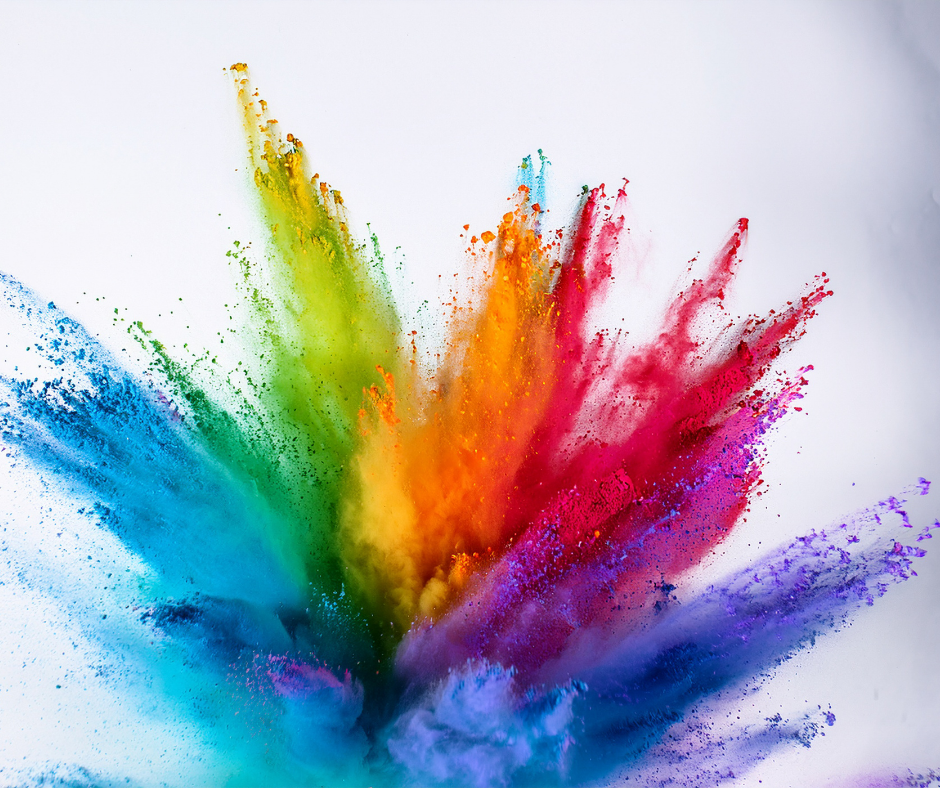 Rainbow color explosion of colored powders.