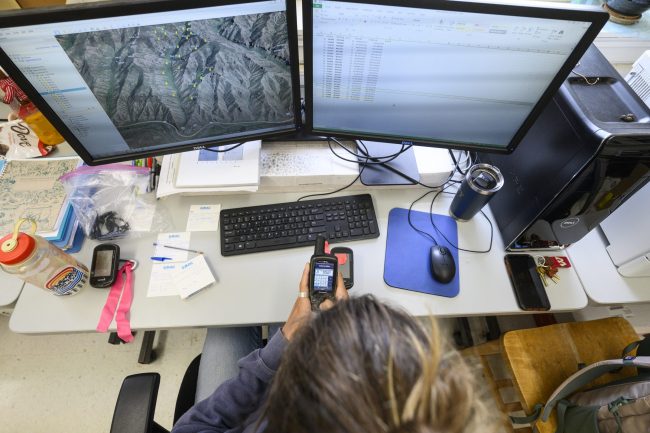 Computer with a landscape map on the screen.